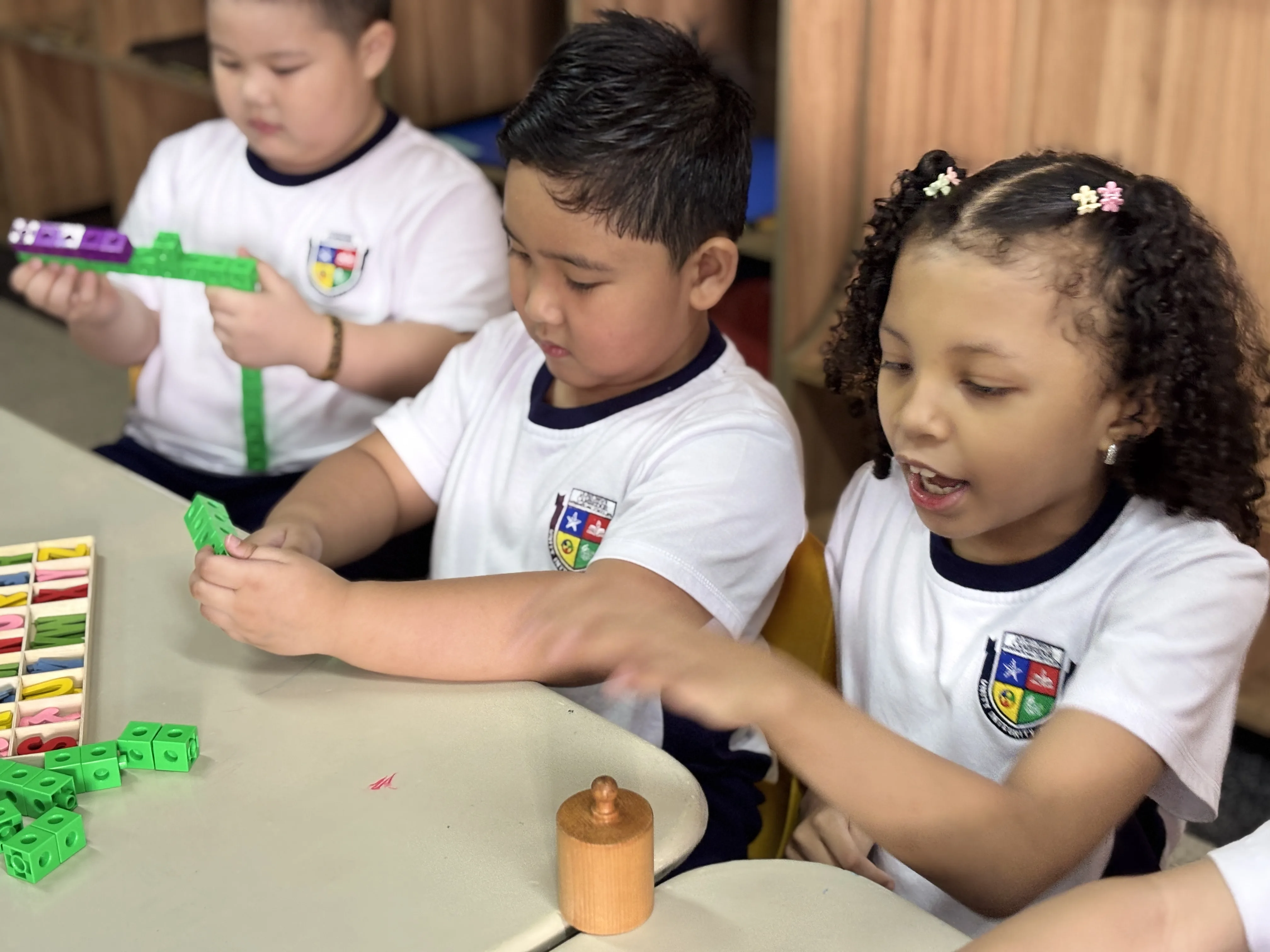 A group of students collaborating on a project at Philippine Cambridge International School (PCIS), highlighting the school's emphasis on teamwork, creativity, and hands-on learning experiences that foster student engagement and success.